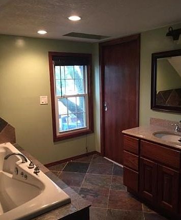 Updated Master bath with heated tile floors and jacuzzi tub.