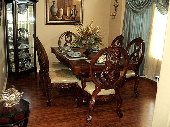 FORMAL DINING OFFERS BEAUTIFUL FLOORING AND CROWN MOLDING