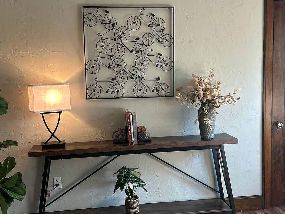 Up close view of the sofa table with decor along the far wall of your living room.