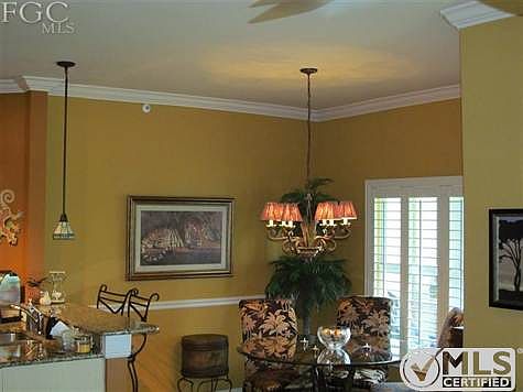 Dinning room featuring Plantation shutters chair railing and custom painting.