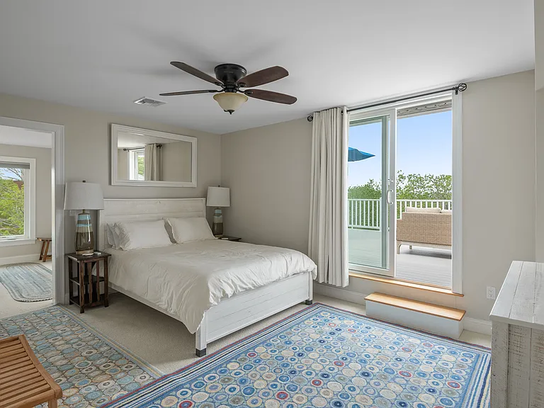 the third floor master bedroom adjacent to the sunbathing deck