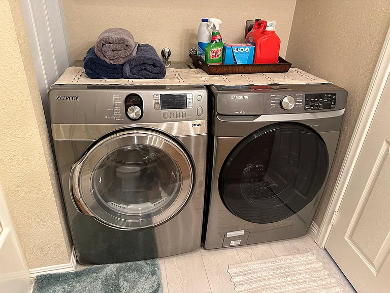 Laundry days are made easier with a washer & dryer in this nook