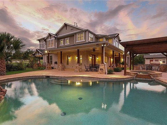 Make a splash in your sparkling Pebble Tec saltwater Pool & Spa, enjoy the cool lake breezes from the wrap-around covered patio or cookout with family under the pergola covered outdoor grill area!