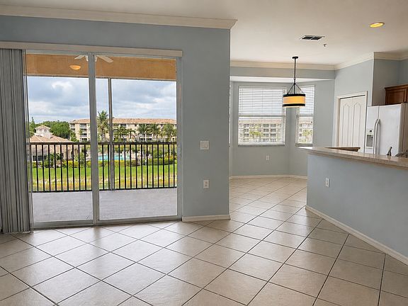 Bright dining area and kitchen with lake views and direct access to the screened lanai