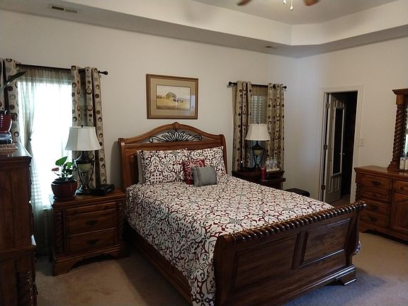 The master bedroom. Notice the vaulted ceilings and the walk-in closet. The entrance to the master bathroom is off screen to the right.