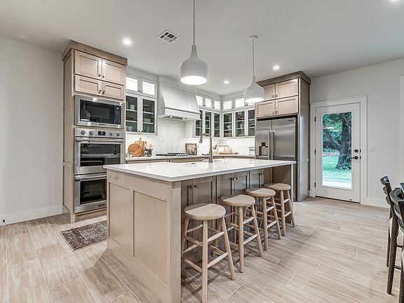 Sleek Kitchen with High-End Appliances, Island Seating & Ample Storage _ Ideal for Entertaining or Everyday Living