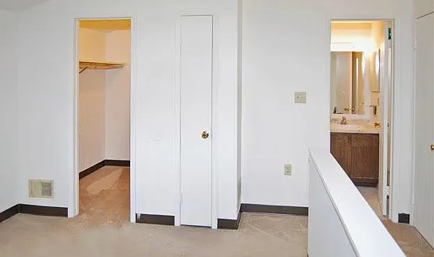 One Primary Bedroom with open loft to first floor. Original bath in this photo. Bath color of tile and fixture may vary.
