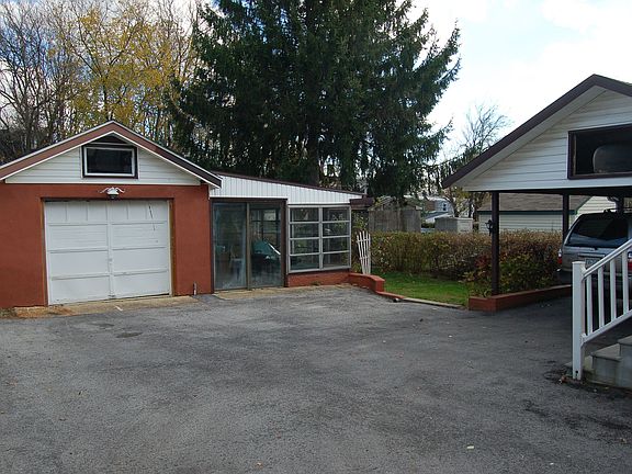 Det garage w/ loft & attached sunporch, and car port