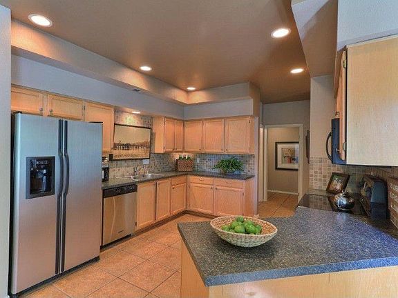 Oversized kitchen with stainless steel appliances, cupboards & counterspace galore.