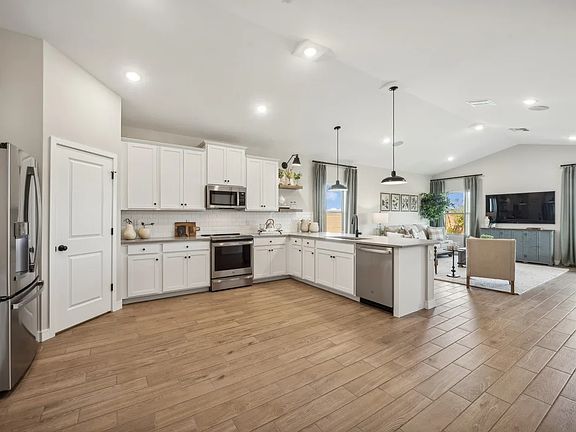Kitchen with vaulted ceiling and pendant lighting