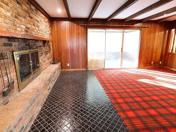Living area with brick mantle and fireplace
