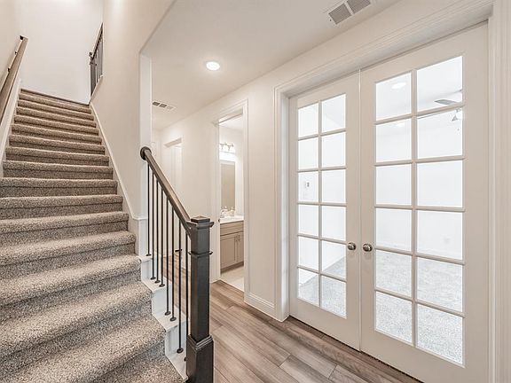Stairs featuring wood finished floors, french doors, and recessed lighting