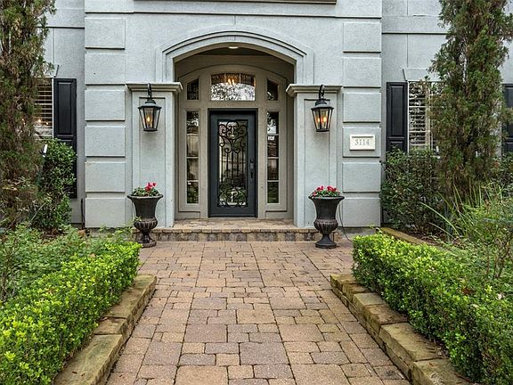 Lanterns flank the iron door entry.
