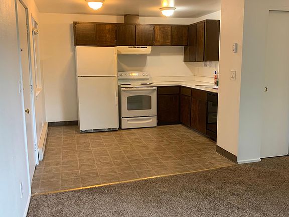view from front corner of living room into kitchen viewing dining area