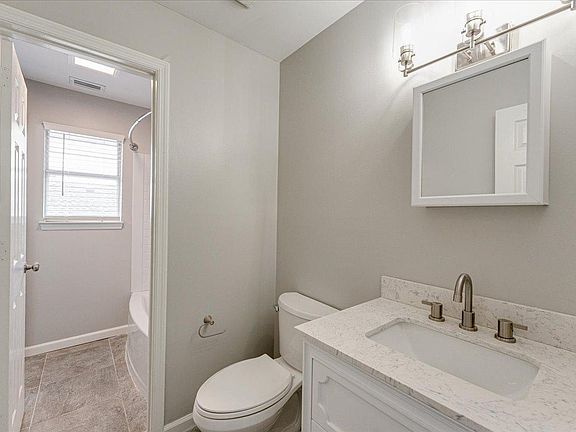 One of two remodeled bathrooms. The separated shower/bathtub room in the rear connects both bathrooms allowing multiple people access to the rooms while maintaining privacy.