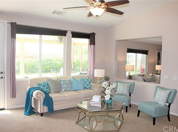 Your Living Room has Large Windows & a Cutout flow to the Family Room Area