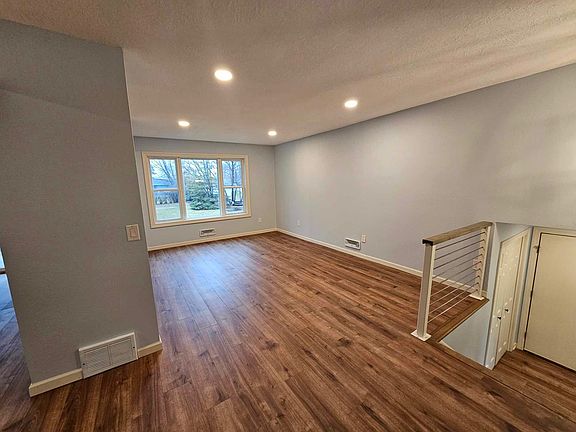 Open-concept main living area with recessed lighting, fresh paint, and updated flooring throughout.