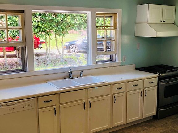 Eat-in kitchen with fridge, dishwasher, range/oven.