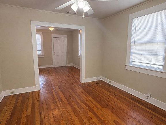 Traditional "Shotgun Style" Layout with ceiling fans and beautiful hardwood floors