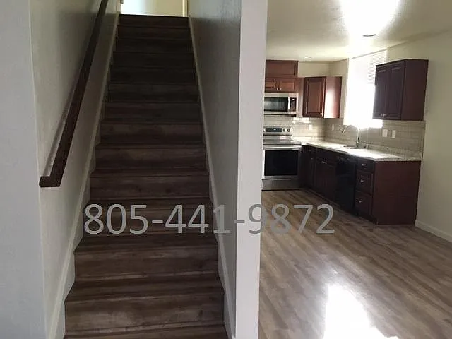 Stairs to 2nd level containing two bedrooms and a bathroom