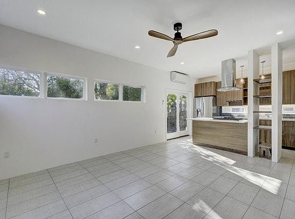 Open living room and glimpse of the kitchen