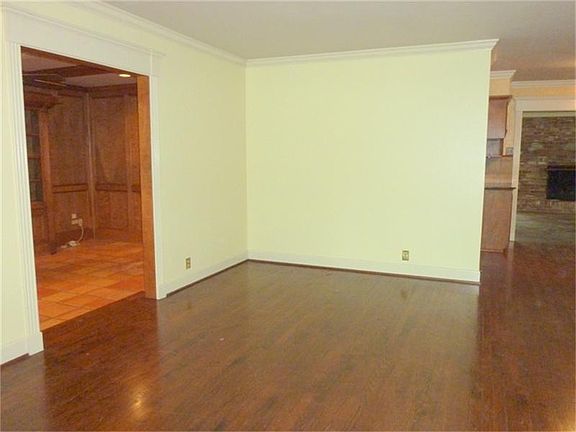 Gleaming hardwoods are located in the living room, dining room and three bedrooms.