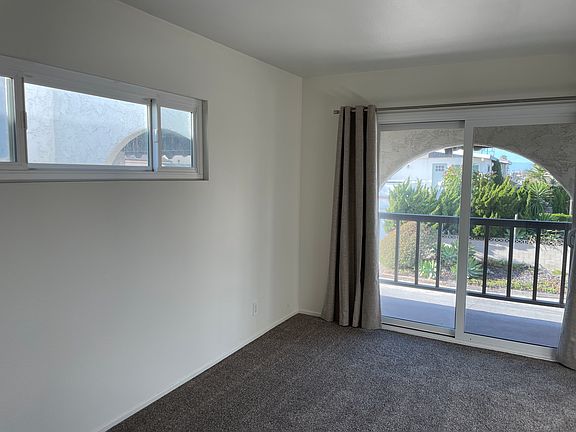 Bedroom 1 new carpet, a balcony facing the street and a bathroom.