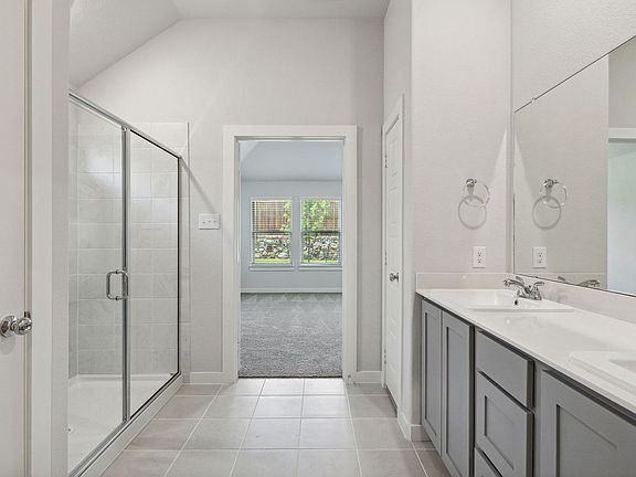 Primary Bathroom in the Quartz home plan by Trophy Signature Homes - REPRESENTATIVE PHOTO