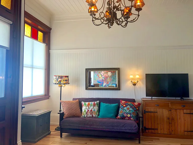 The futon couch is a great place to relax or work, providing amazing views and good lighting on both sides of the couch.