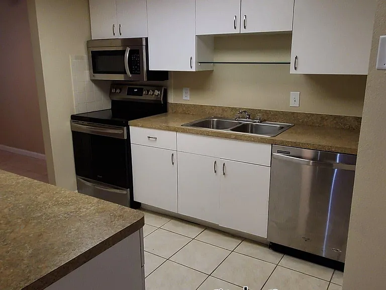 Kitchen has been upgraded with new stainless steel appliances and a new light fixture.