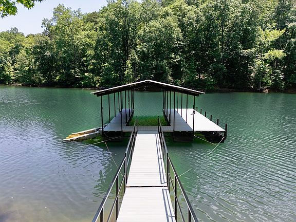 Nestled on a quiet, deep-water cove, this home offers exclusive access to a private dock_your gateway to peaceful lakefront living. Whether you're fishing, swimming, or launching your kayak, the dock provides the perfect spot to soak in serene views.