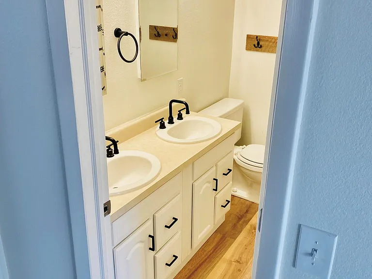 Double vanity with storage behind each mirror.