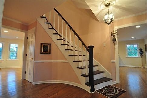 Curved staircase greets you at the front door