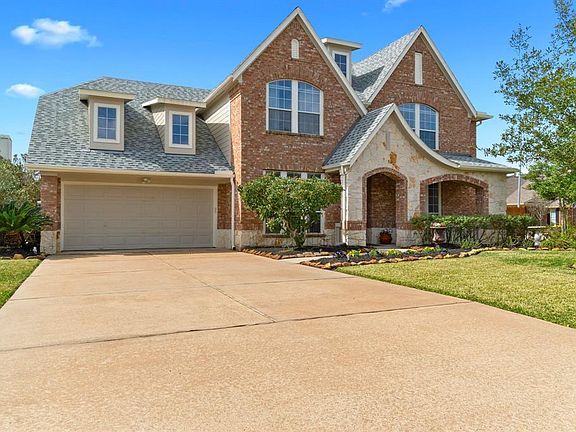 Driving up you will notice the beautiful manicured shrubs and flower beds