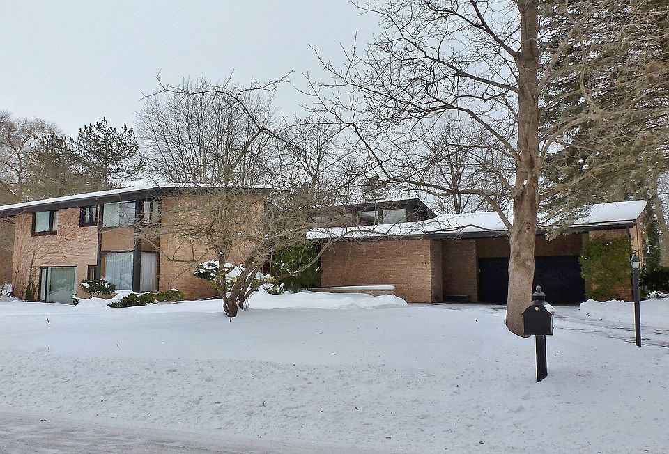 TIMELESS Mid-century modern brick home with over 3700 square feet and backs up to the Midland Country Club on a 1.38 acre lot!  Original architectural details maintained with modern updates throughout!  Features original kitchen cabinets, newer walnut floors, main floor master bedroom with marble bathroom, bidet/toilet combo, claw-foot tub and glass-enclosed shower, spacious main floor laundry with stackable washer & dryer included, vaulted beamed ceilings in the formal dining room and living room, 3 fireplaces, slate floors in the large foyer and on the 2-tiered back patio, deck, 3 upstairs bedrooms, main floor den or 5th bedroom, finished lower level with large family room and wet bar, new roof 2013, newer boiler with on-demand hot water, newer gas forced-air furnace and central air, whole house generator, 16 new windows, garden shed attached to back of house, sprinkler system!  Classic home that must be seen to appreciate!!