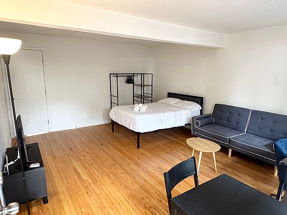 Bedroom w patio access. Pictured as currently furnished