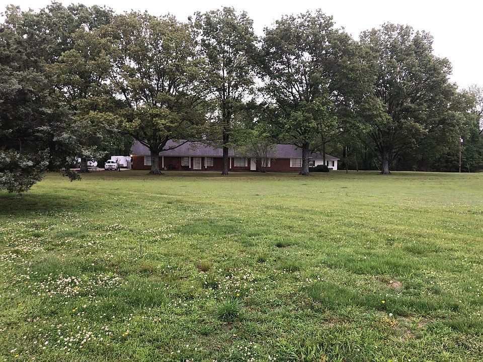A distant view of the grounds on which the three cottages sit alongside a large home which serves as a quadplex.