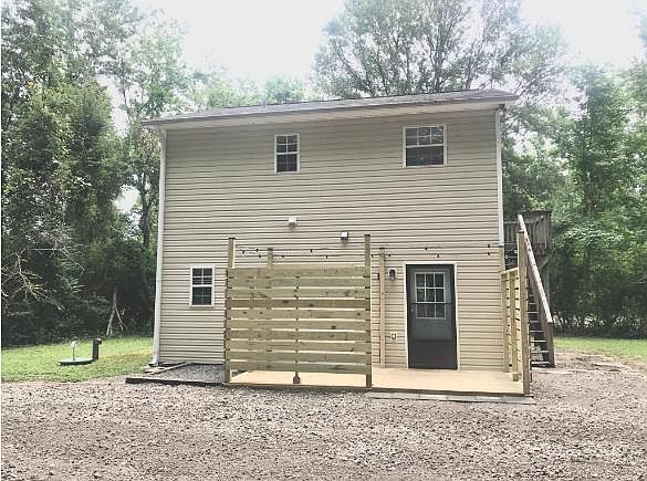 The ground floor studio unit features walk out deck with privacy walls and string lights.
