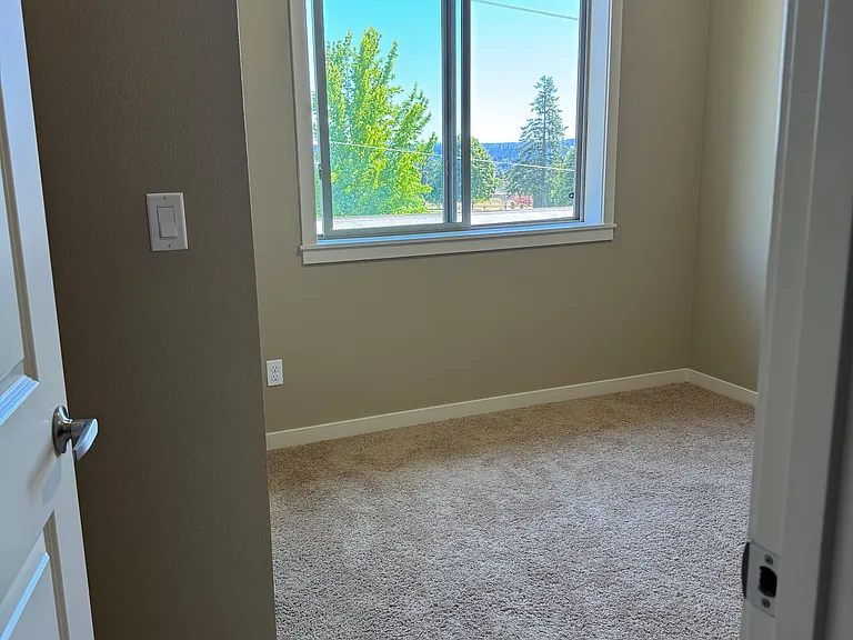 bedroom with built in desk and cabinets