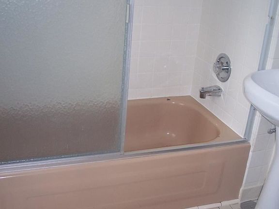 bathroom with tub and shower