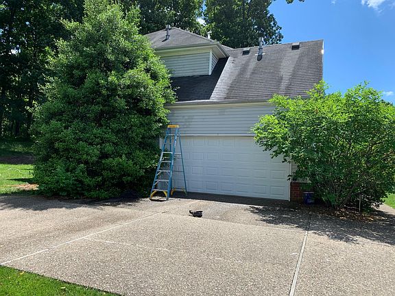 Two car garage with plenty of parking outside
