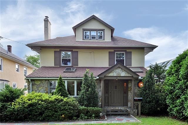 House with stone front and bluestone path
