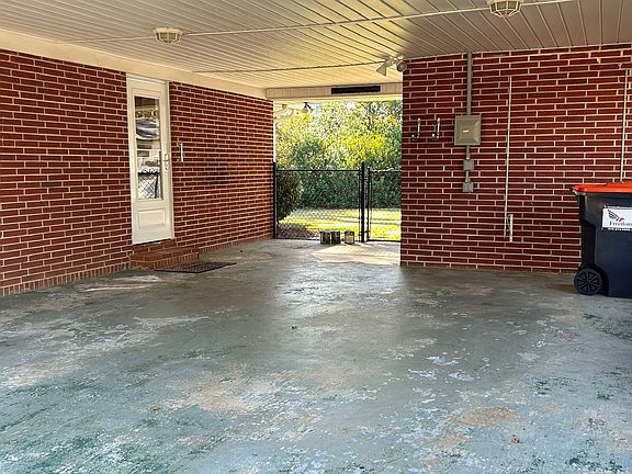 Carport, storage room and kitchen entry