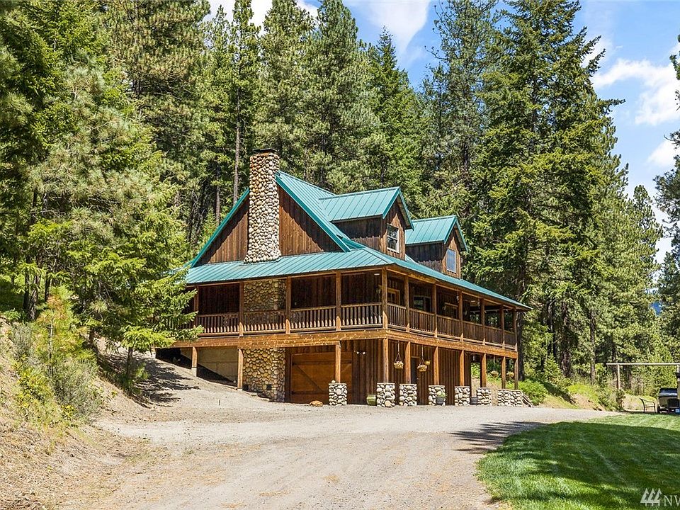 Liberty area home resting below Moonlight Ridge! Gorgeous bat & board style cabin with river rock fireplace & charming wrap around porches.
