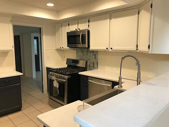 Kitchen with brand new stainless gas range, microwave, dishw