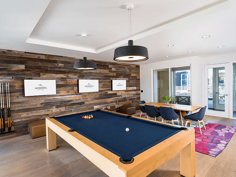 A resident game lounge at Modera Belmont, featuring billiards and gathering space just moments from Belmont's neighborhood dining and shops.