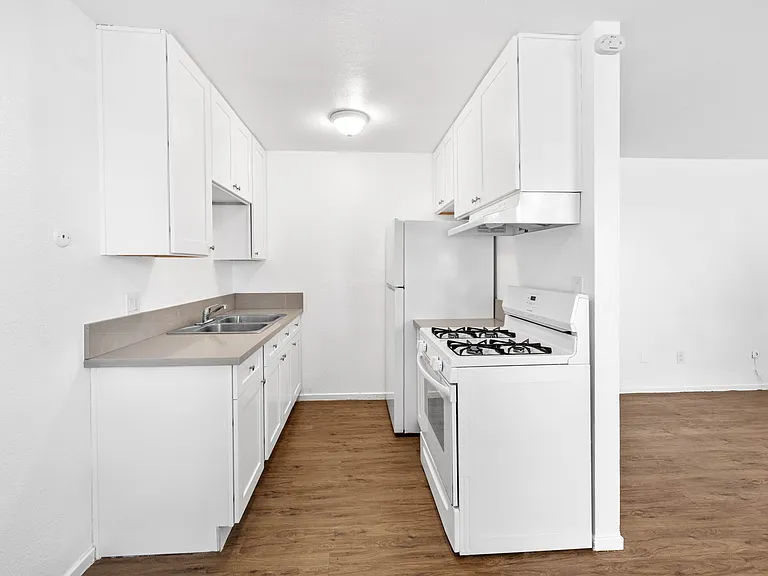 New kitchen appliances including stove/oven and frig/freezer with new cabinets and counters