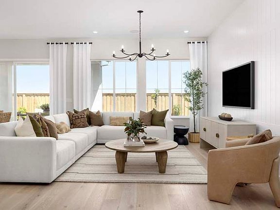 Open-concept gathering room with plenty of sunlight