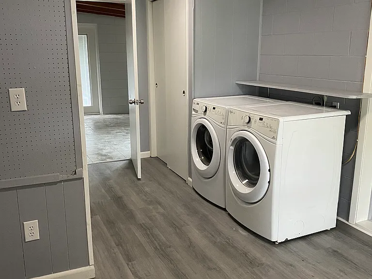 Mudroom with modern washing machine, dryer and ample closets