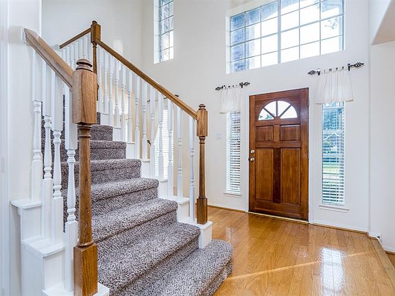 Grand two story entry with tons of natural light and wood floors.